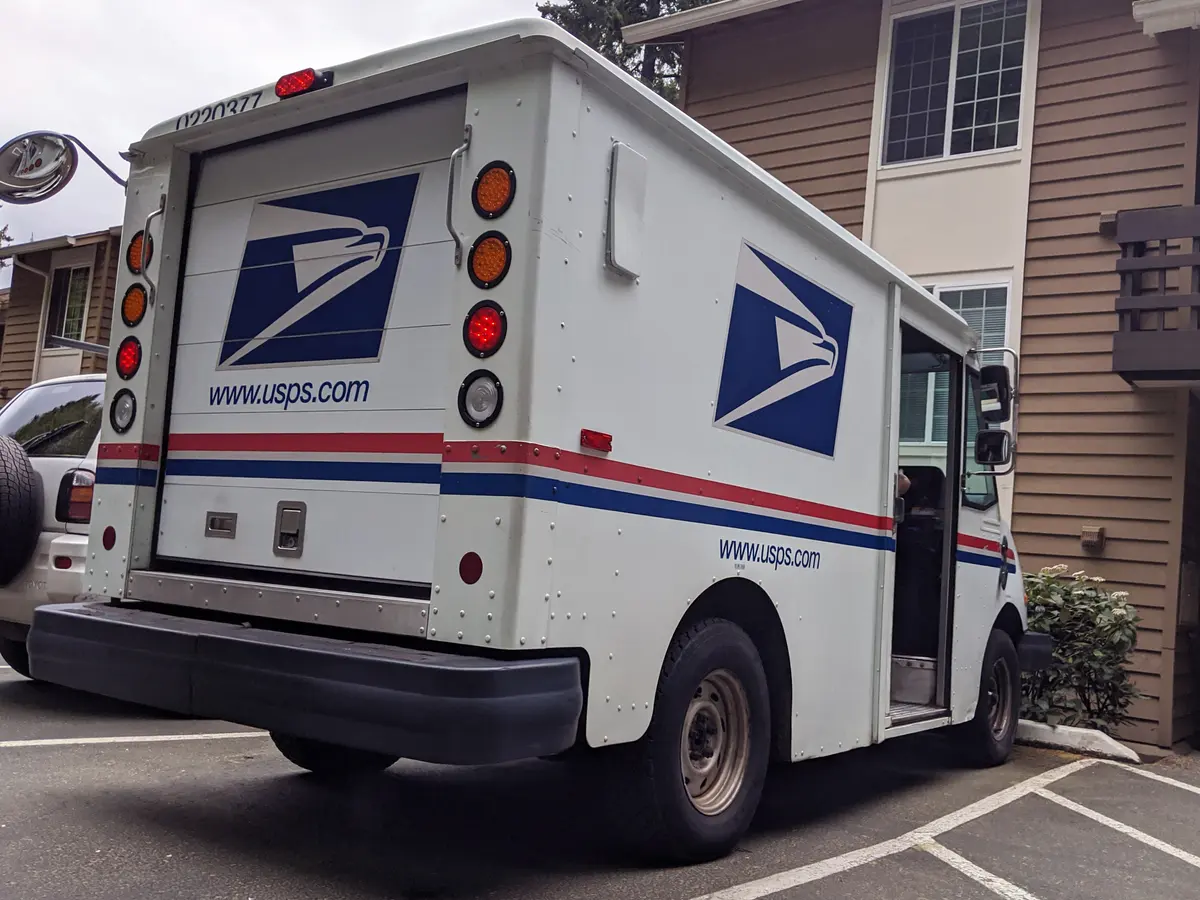 Postal delivery truck parked on a residential street